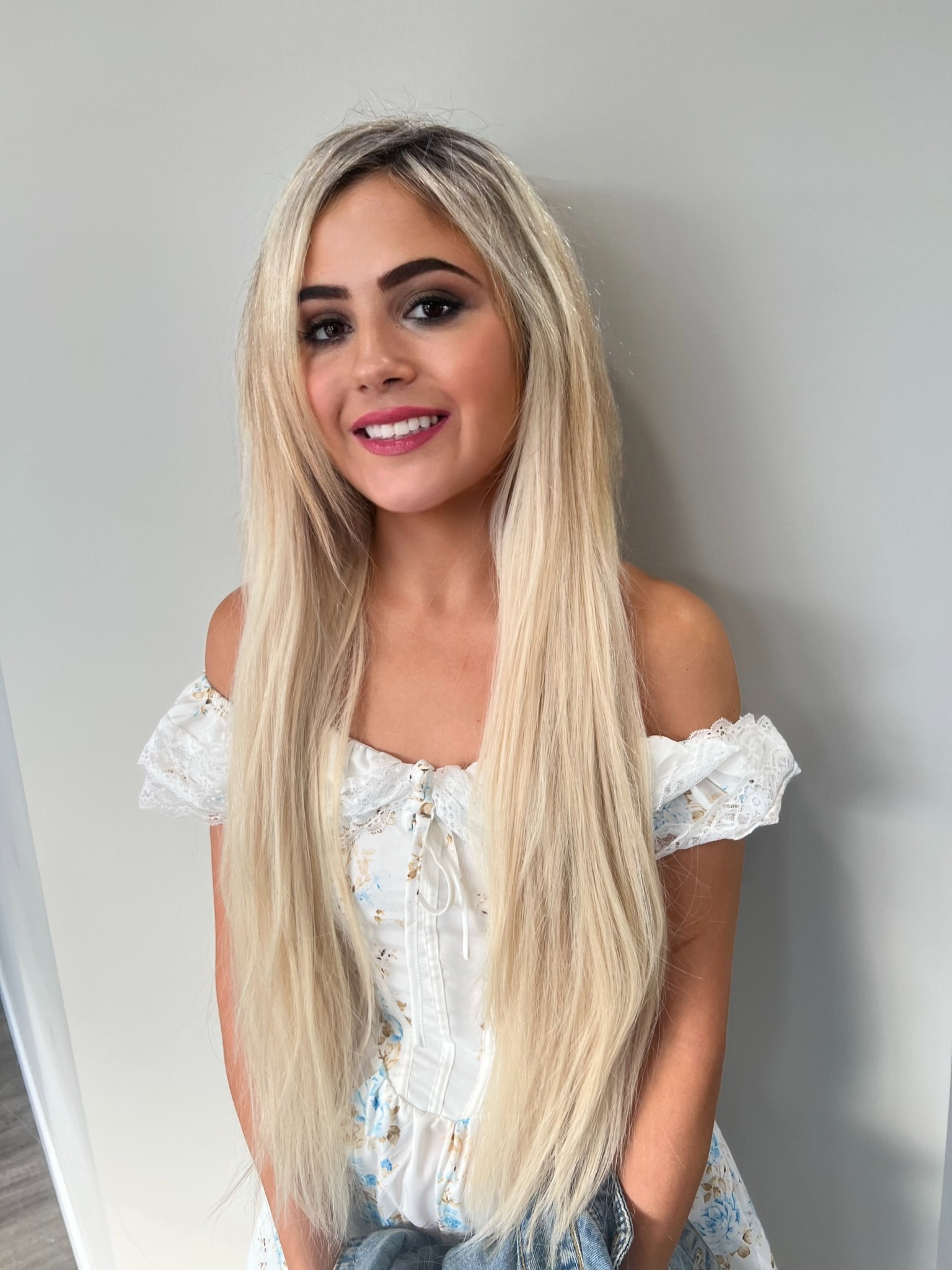 Long blonde hair extensions styled at New Synergy Salon